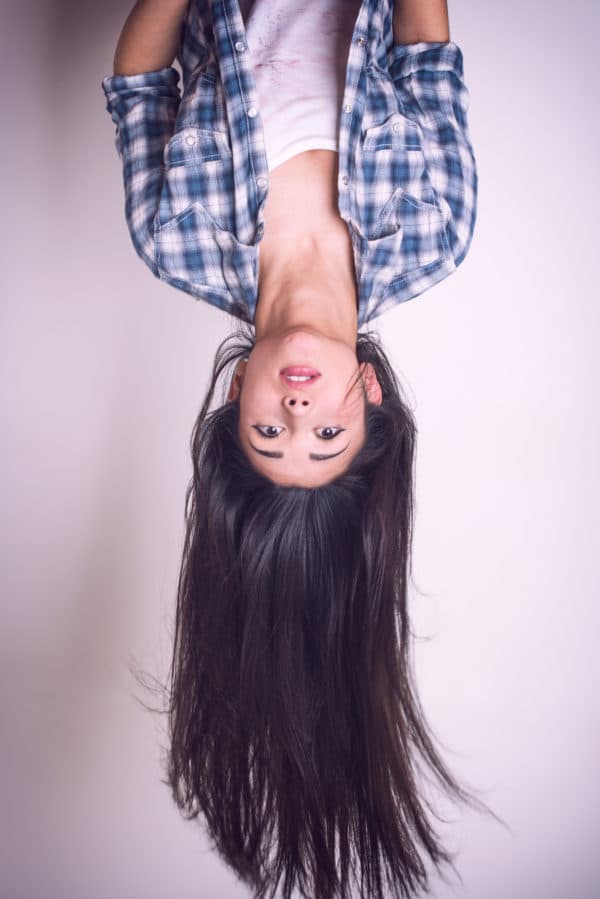 Pretty young woman hanging upside down BloomingYou